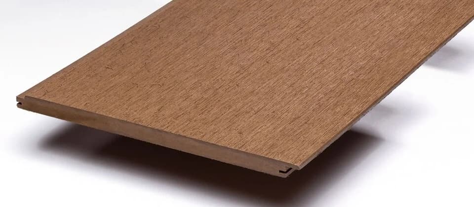 A wood-plastic composite cladding sample with a visible edge profile and wood-look surface.