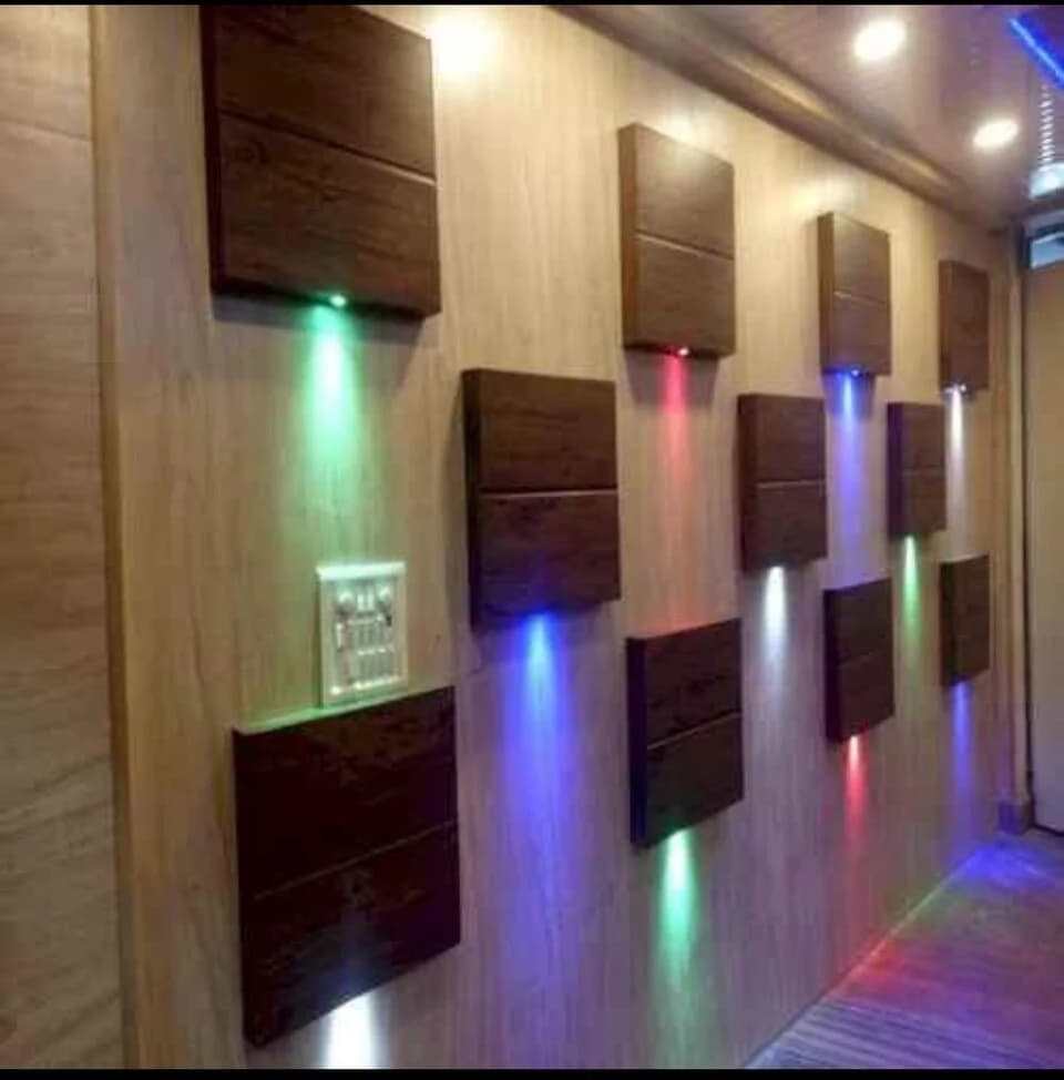 Decorative wall panels arranged around lighting and electrical fittings in an interior reference photo.